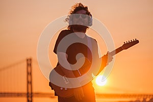 Street musician playing electric guitar in the street