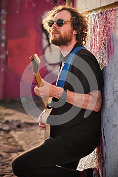 Street musician playing electric guitar in the street