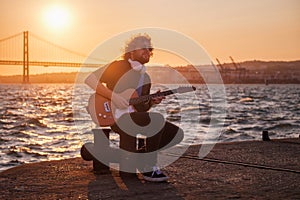 Street musician playing electric guitar in the street