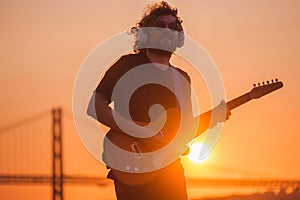 Street musician playing electric guitar in the street