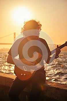 Street musician playing electric guitar in the street