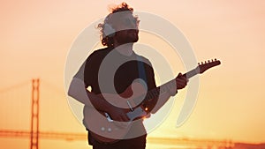 Street musician playing electric guitar in the street