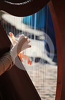 Street musician playing Harp in the streets of milan