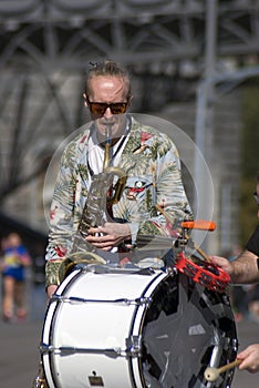 Street musician plays music. Color photo.