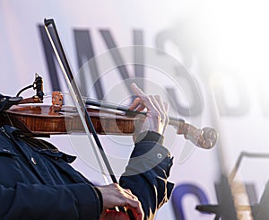 street musician violin plays music outdoors