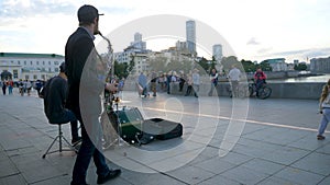 Street musicians play jazz on the town square. Musicians in the town square singing and playing