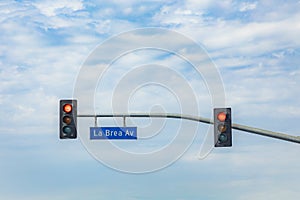 Street name La Brea Avenue in Hollywood with red traffic light