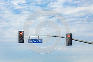 Street name La Brea Avenue in Hollywood with red traffic light photo