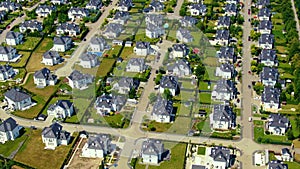 Street with new homes in spring season. Single family houses and residential construction planned community. Aerial from backyard