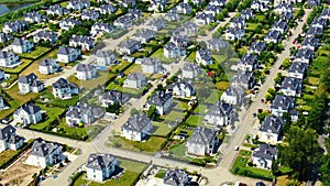 Street with new homes in spring season. Single family houses and residential construction planned community. Aerial from backyard