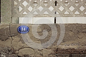 Street number 14 on an old wall photo