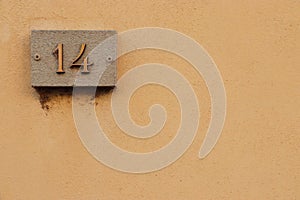 Street number sign, number fourteen on the top left corner photo