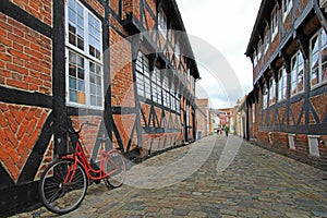 Street with old houses and vintage bicycle, royal town Ribe, Denmark