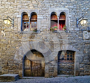 Street of an old medieval town with stone houses and cobbled floors, street lamps and an atmosphere of bygone times