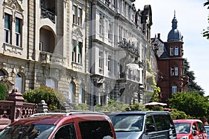 Street with old residential houses and parked cars in Constance