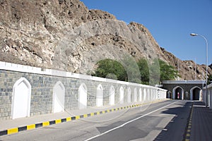 The street into Old Town Muscat, Oman with gates and tunnel in and through the mountains.