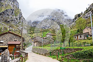 Street with old typical houses in a cloudy spring day, Cain de Valdeon, Picos de Europa, Castile and Leon, Spain. Cain is a villa