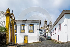 Street in Ouro Preto City with Sao Francisco de Assis Church on backgound - Ouro Preto, Minas Gerais, Brazil photo