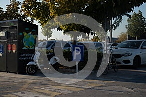 Street parking for cars and mopeds. cars in the parking lot