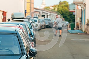 Street parking, cars on urban town street parked at the side of the road