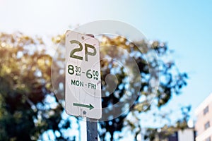 Street parking sign with parking rules not to park for more than two hours - 2P - on weekday mornings in New South Wales