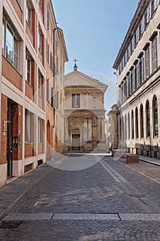 A Street in Parma and in the Background the deconsecrated Renaissance Church of San Marcellino, Italy