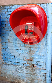 Street payphone telephone set in a red booth
