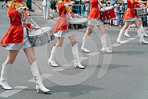 Street performance. Close-up of female drummers hands in red vintage uniform at the parade