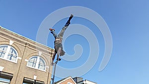 Street performer doing hand stand