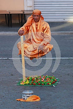 Street performer, man levitating in Rome, Italy