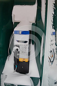 Street phone booth covered with snow after strong storm