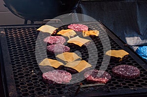 Detail of the portable brass grill of the chef. Grilling burgers and cheeseburgers with burning coal BCoqueiro photo