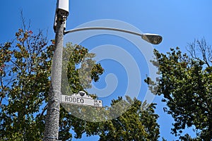 A Street Pole Sign indicating the Direction to Rodeo Drive in Beverly Hills - Los Angeles, California