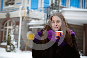 Street portrait of glorious young woman wearing purple knitted s
