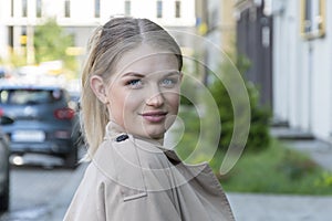 Street portrait of a happy young and beautiful blonde girl 20-25 years old.