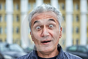 Street portrait of a surprised middle-aged man