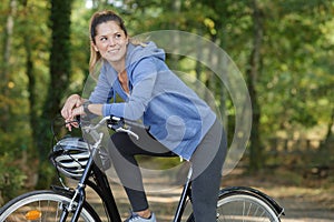 street portrait young beautiful woman with bicycle