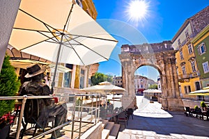 Street of Pula with historic Roman Golden gate and James Joyce s
