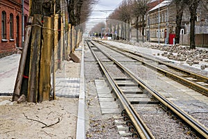 Street reconstruction, tree trunks with board protectors, newly replaced tram tracks and pavement photo