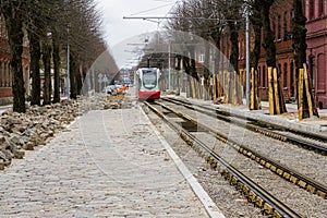 Street reconstruction, tree trunks with board protectors, newly replaced tram tracks and pavement photo