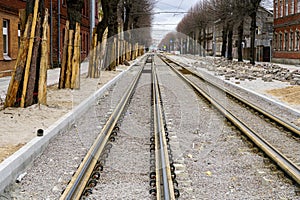 Street reconstruction, tree trunks with board protectors, newly replaced tram tracks and pavement photo