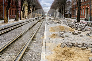 Street reconstruction view with replaced tram tracks, pavement with cube shape granite stones