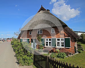 Street and reed roofed house in Stahlbrode in Mecklenburg-Vorpommern. The building is a listed monument