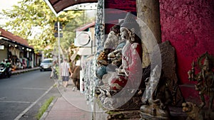 street religious statues in ubud standing on the street, street and passersby