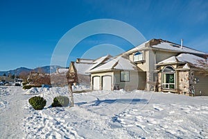 Street of residential houses in snow on winter sunny day