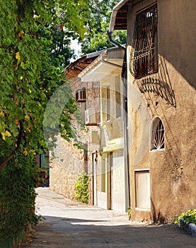 A street in a resort town on a clear sunny day. Old houses, masonry. Heat, warmth, sunshine. Beautiful picture.