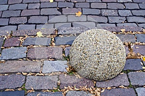 Street road brick background and granite ball