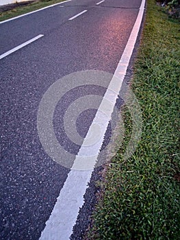 Street road line in sunset and traffic lights and Street light shining on perspective ending