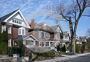 Street with row of large older brick detached houses