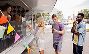 Happy customers queue at food truck